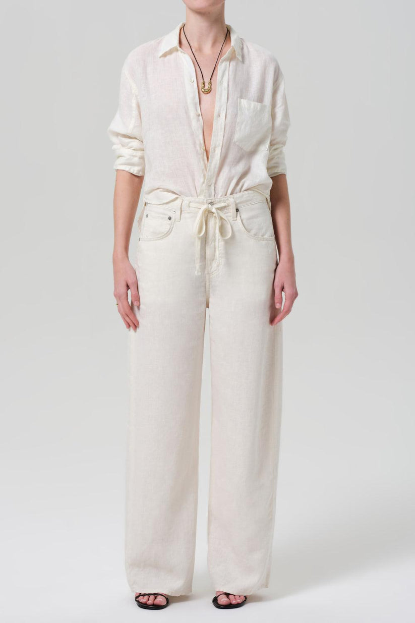 a woman in white pants and a shirt