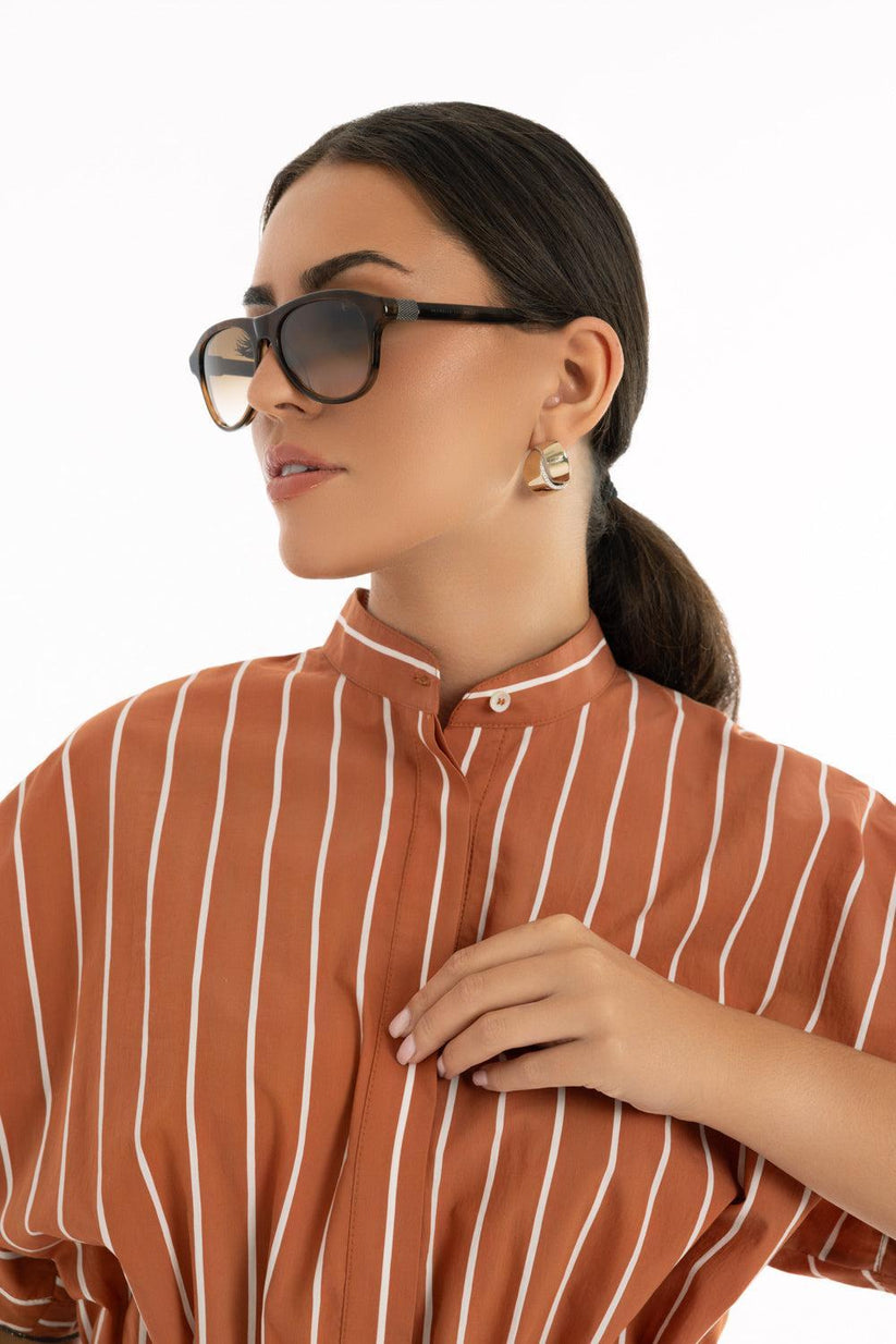a woman wearing sunglasses and a striped shirt