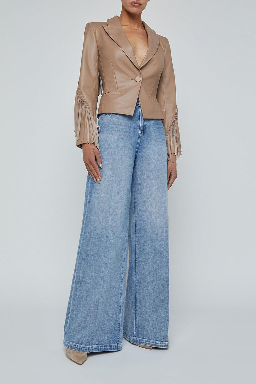 a woman wearing a leather jacket and jeans