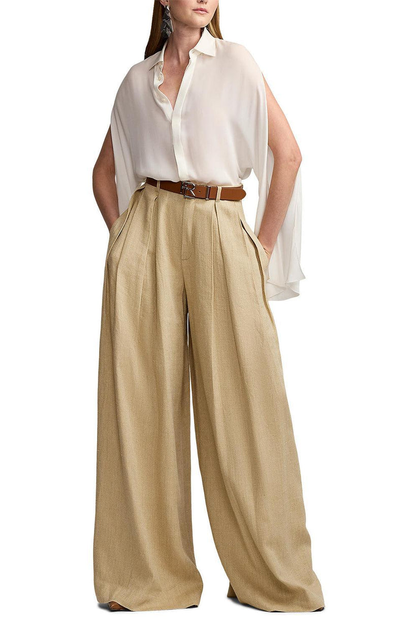 a woman in a white blouse and beige pants